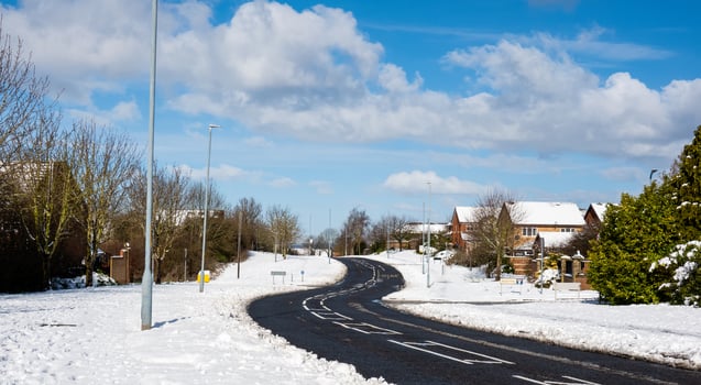 Winter landscape with snow covering the road in village, Snow on street road in small town with bright light morning. photo