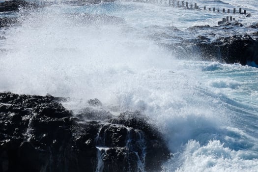 Large waves crashing against the rocks in the ocean photo