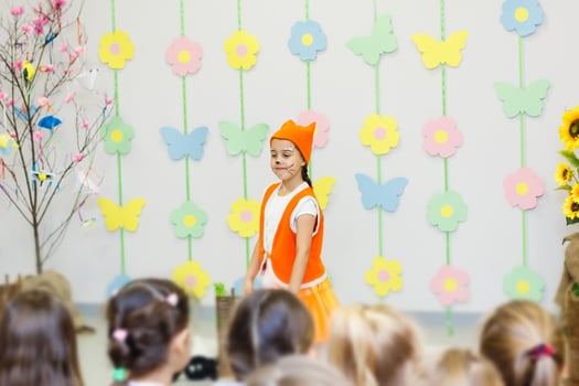 young actress in a fox costume speaking in front of children photo