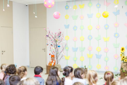 young actress in a fox costume speaking in front of children photo