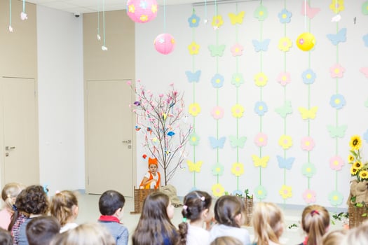 young actress in a fox costume speaking in front of children photo