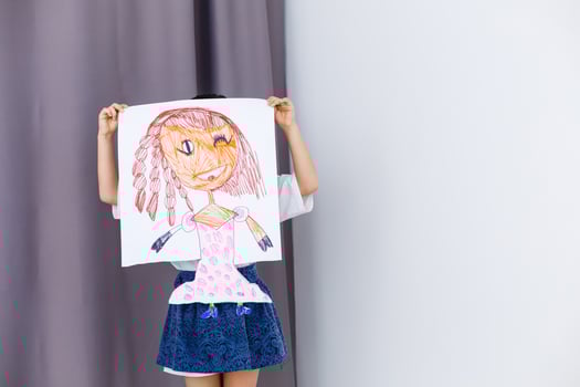 Little prescholer girl holding her portrait picture photo
