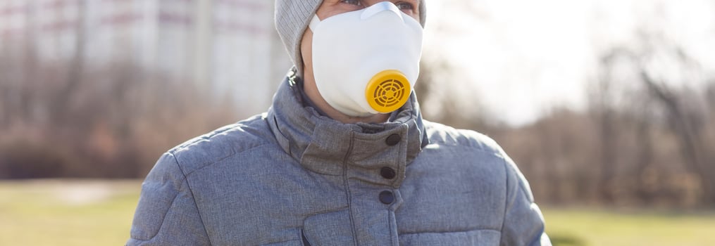 A man wearing a mask on the street. Protection against virus and grip photo