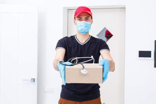 Delivery man holding cardboard boxes in rubber gloves and medical mask. copy space. Fast and free Delivery transport . Online shopping and Express delivery photo