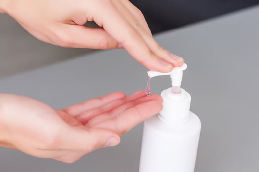 man hands using wash hand sanitizer gel dispenser, against Novel coronavirus or Corona Virus Disease at public train station. Antiseptic, Hygiene and Healthcare concept photo