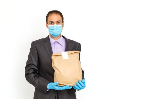 Young businessman wearing protective coronavirus medical mask on white background. Concept of health and safety life, N1H1 coronavirus, virus protection, pandemic in world photo
