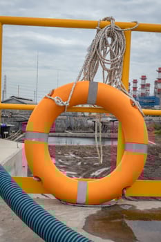 Safety flotation ring on water storage and water treatment area, for emergency action. The photo is suitable to use for safety background photography, power plant poster and electricity content media.