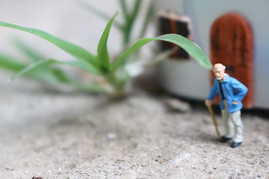 miniature figure of a grandfather who is waiting in front of the house. photo