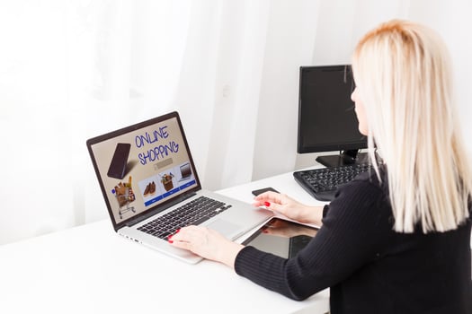 Woman shopping online using her laptop at home photo