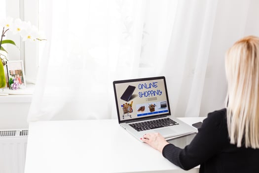 Woman shopping online using her laptop at home photo