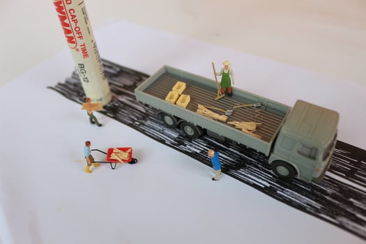 Bogor, Indonesia - October, 19 2022. minature figure of workers moving wood onto a truck. photo