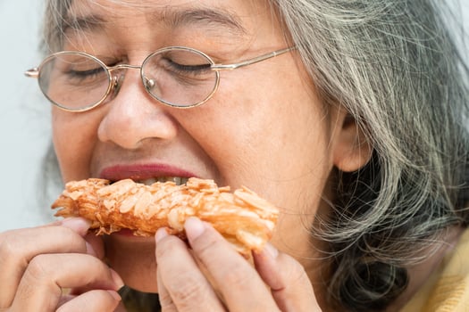Happy Asian senior women enjoying eating pie photo