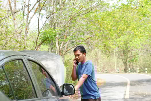 man called a mechanic to come look at the broken car. photo