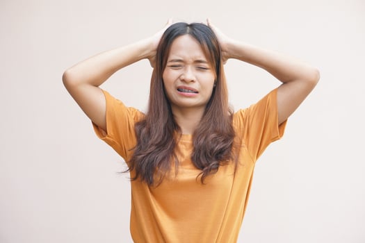 Asian women suffer from headaches from thinking about work. photo