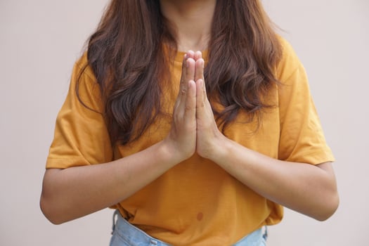 Asian woman making a wish from the holy things photo