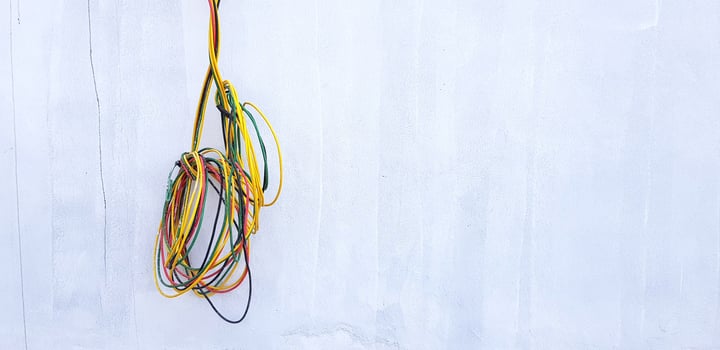Red, Black, Yellow and Green cable hanging or isolated on gray concrete wall with copy space. New installation wiring power cord, Connection, Repair building and Industrial Electrical system photo