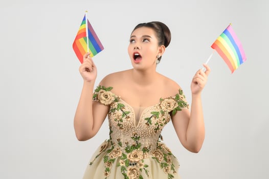 Young asian beautiful bride with rainbow flag on white background photo
