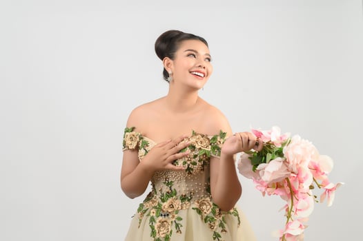 Young asian beautiful bride with orchid bouquet on white background photo