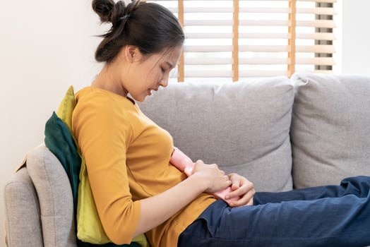 Menstruation, period cycle of monthly, hurt asian young woman, female hand in stomachache, suffer from premenstrual, belly or abdomen pain, using hot water bag. Health problem Inflammation in body. photo