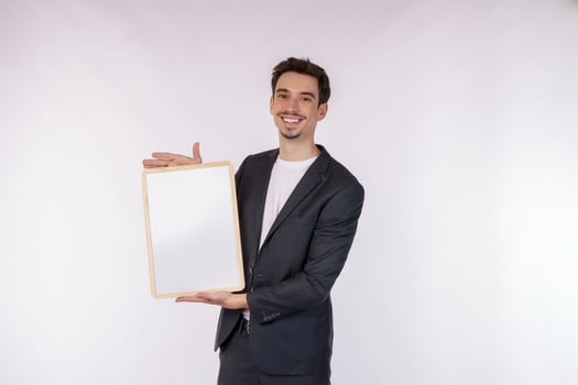 Portrait of happy businessman showing blank signboard on isolated white background photo