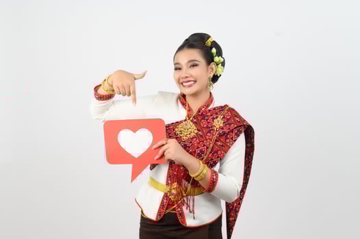 Young beautiful woman in Thai lanna costume with card card in heart symbol photo