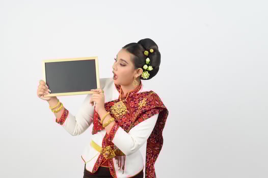 Portrait of Beautiful Thai Woman in Traditional Clothing Posing with blackboard photo