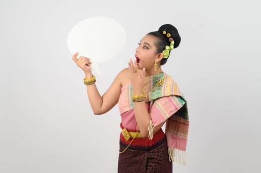 Young beautiful woman in Thai lanna costume with blank speech bubble sign photo