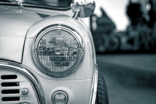 close up head light classic car and road photo