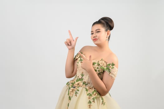 Young asian beautiful bride point finger with happy on white background photo