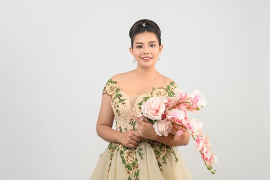 Young asian beautiful bride with orchid bouquet on white background photo