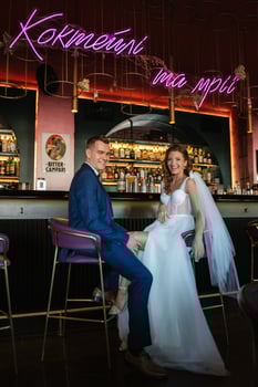 bride and groom inside a cocktail bar photo