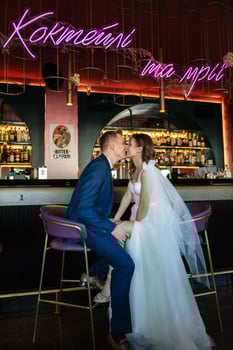 bride and groom inside a cocktail bar photo