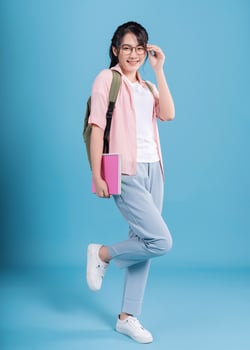 Young Asian student on blue background photo