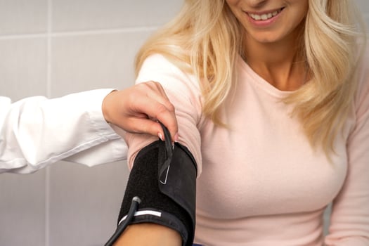 Doctor puts on tonometer on arm photo