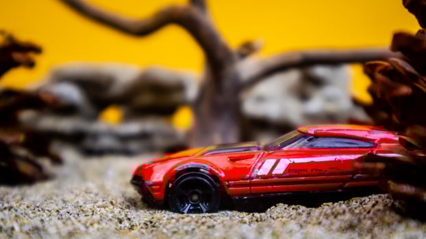 Minahasa, Indonesia saturday, December 2022, a toy car among the pinecones photo