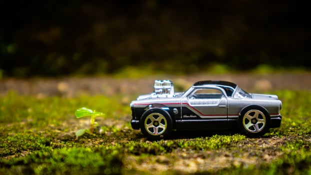 South Minahasa, Indonesia  January 2023, a toy car on a mossy floor that looks like grass photo