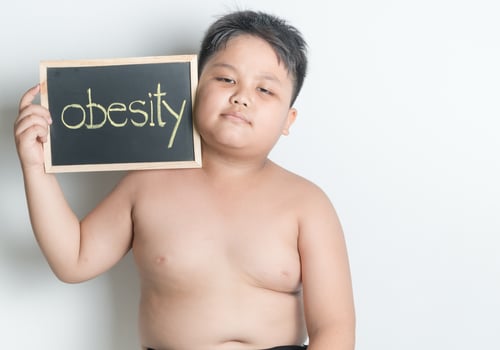 fat boy hold blackboard photo