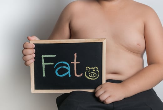 obese fat boy holding blackboard photo