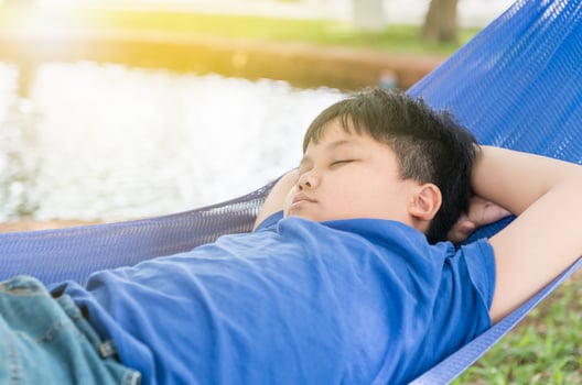 obese fat boy sleep on cradle photo