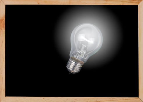 bulb light on blackboard photo
