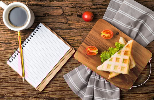sandwich and coffee with blank notebook photo