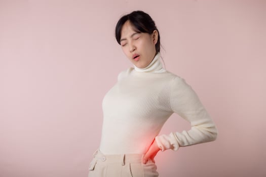 Young woman have waist pain, back ache, lumbar muscle injury problem. Office syndrome disease sick. Healthcare concept. photo