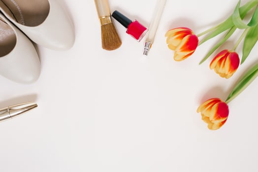Still life of a fashionista. Women's cosmetic background. Flat lay for Valentine's Day. Stylish accessories, a bouquet of tulips and blogger's clothes. Copying a space photo