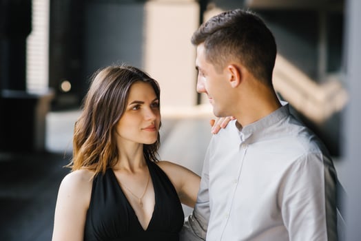 Portrait of a young beautiful couple. The girl looks into the eyes of her loved one and smiles. First date and the concept of tenderness photo