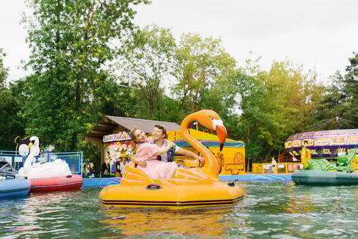 Happy couple in love riding a water ride in an amusement park photo