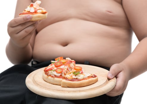 Pizza in wood plate with obese fat boy background isolated photo