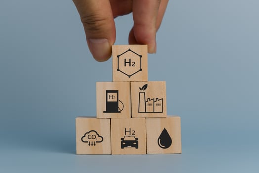 hand holding wood cube.Climate and eco friendly energy in the future for net zero emissions target.Changing CO2 to H2 fuel cell concept. photo