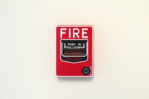 Fire alarm switch on white wall background photo