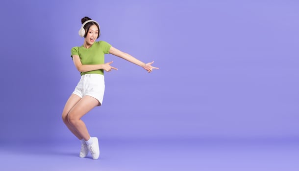 full body image of beautiful asian girl posing on pink background photo