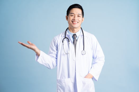 Asian male doctor portrait on blue background photo